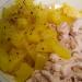 Making an unusual salad with pineapples and smoked chicken